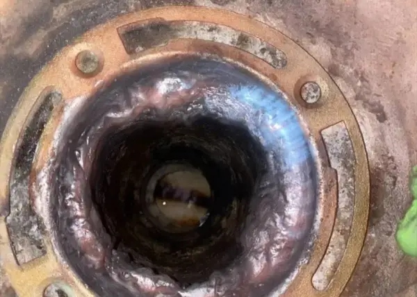 Close-up of a corroded drain flange before replacement by Haltex Plumbing