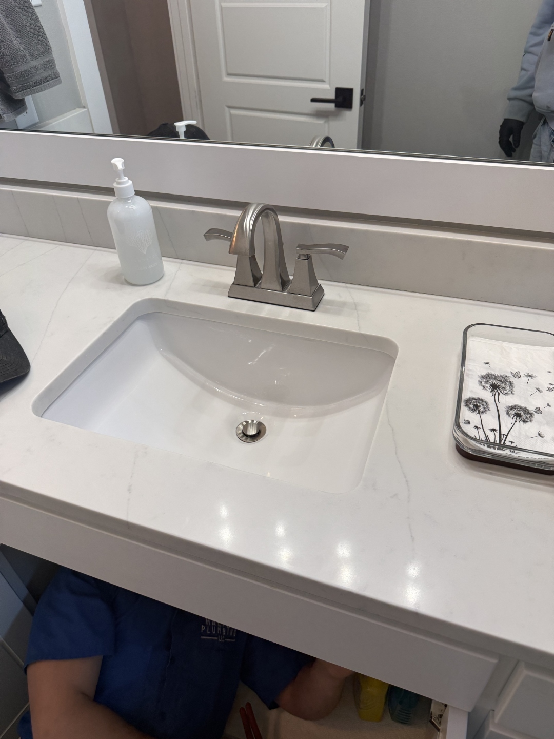 Finished bathroom faucet installation on quartz vanity by Haltex Plumbing