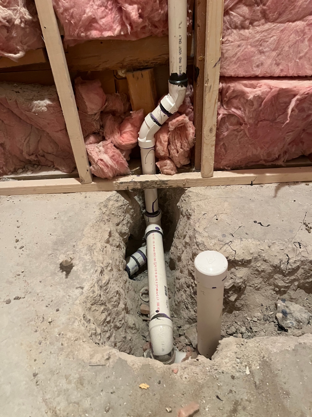 New construction plumbing rough-in with PVC drain and vent piping