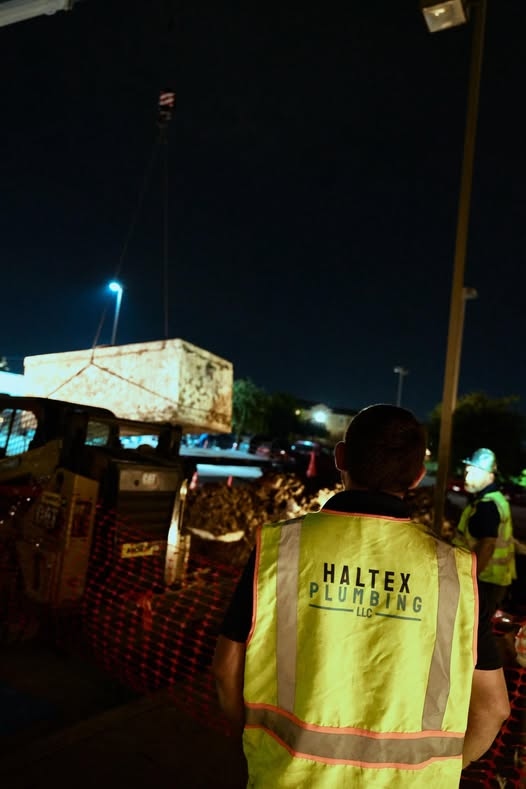 Haltex crew member working a night shift on a commercial grease trap installation