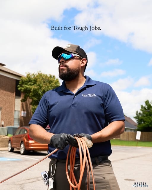 Haltex plumber holding tools with Built for Tough Jobs branding