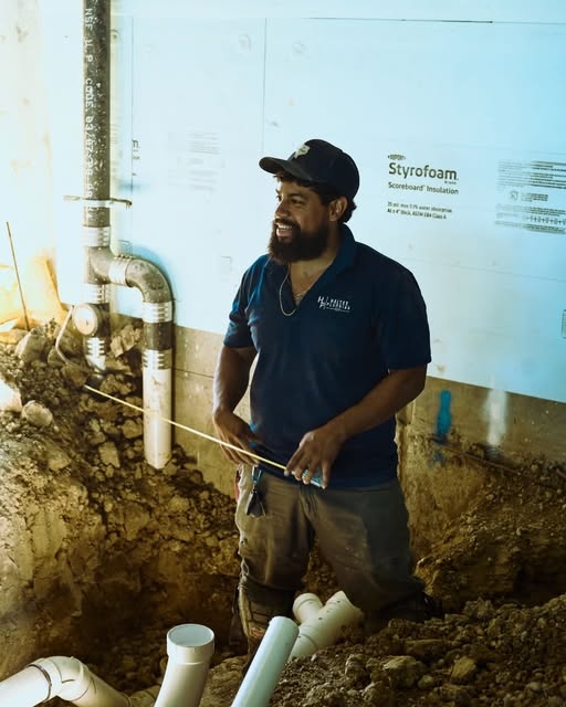 Haltex plumber working in excavation on a pipe repair job
