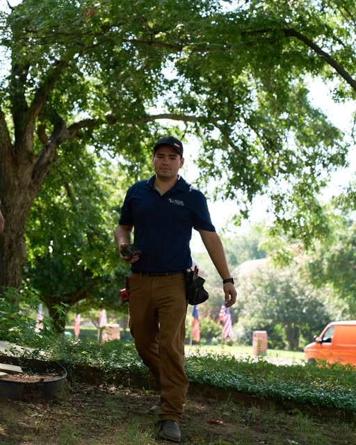 Haltex plumber walking through yard with tools ready for service